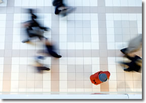 Person pausing in a hectic crowd