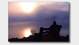 Man Sitting in front of Lake