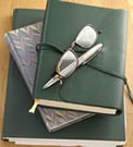 photo of journals, pen and reading glasses